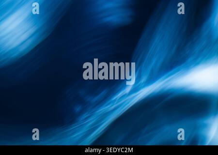 Smooth flowing abstract blue waves resembling soft smoke or liquid motion Stock Photo