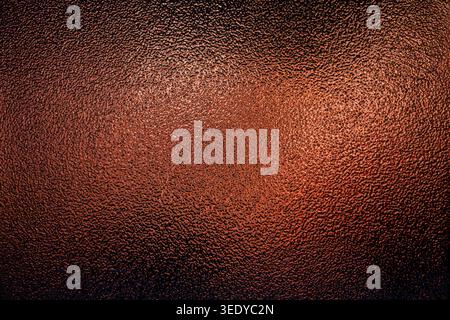 Copper colored frosted glass texture with a rough bumpy surface and warm gradient light Stock Photo