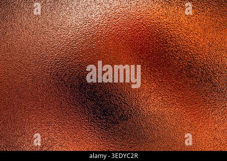 Bright copper colored frosted glass background with uneven textured surface and central illumination Stock Photo