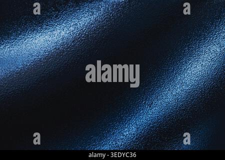 Abstract dark blue textured surface with diagonal light streaks Stock Photo