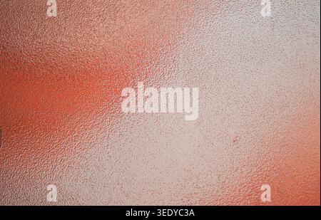Warm orange textured frosted glass background with subtle bright reflections Stock Photo