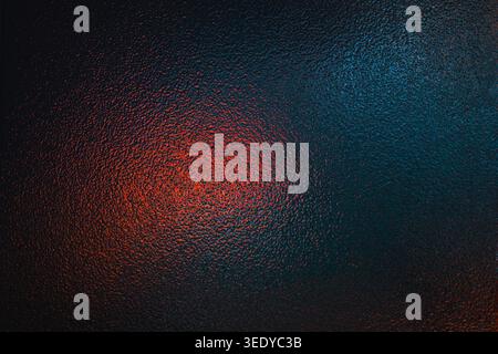 Dark textured background illuminated by contrasting red and teal neon lights Stock Photo