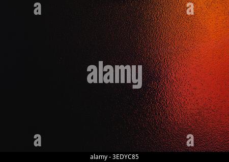 Dark textured material surface with a bright red and orange light glow on the right edge Stock Photo