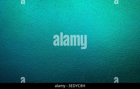 Vibrant teal green gradient light reflecting on a textured opaque glass background Stock Photo