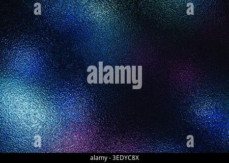 Dark frosted glass texture illuminated by vibrant neon blue and purple lights Stock Photo