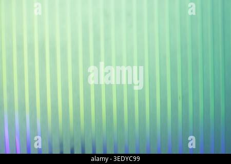 Bright vertical ribbed texture lit by soft green and blue pastel gradient colors Stock Photo