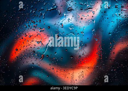 Macro water drops on glass surface with vibrant red and blue background Stock Photo