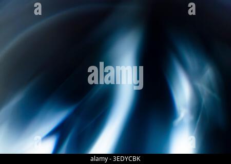 Abstract blurred background with flowing blue and white light streaks Stock Photo