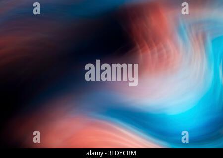 Abstract flowing waves of blue and red colors blending in a smooth gradient background Stock Photo