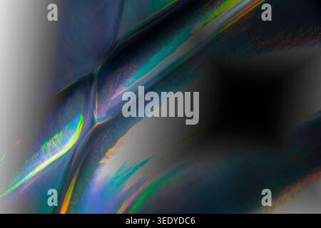 Iridescent light streaks sweep through a dark abstract frame, blending blue, green, yellow and violet tones with soft blur, reflective textures and a Stock Photo