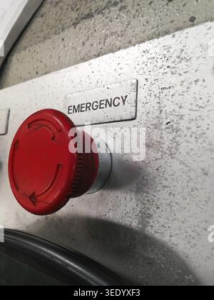 Close up of red emergency button which is used to stop the operation of a machine Stock Photo