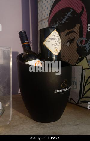 Santorini, Greece - October 8, 2025 - Two bottles of wine from Estate Argyros winery in a black ice bucket. Stock Photo