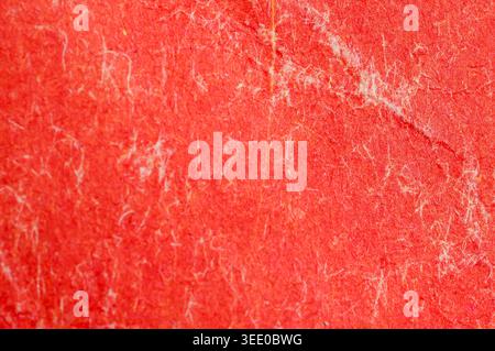 Detailed abstract background showcasing the intricate texture and fibrous nature of vibrant red paper material Stock Photo