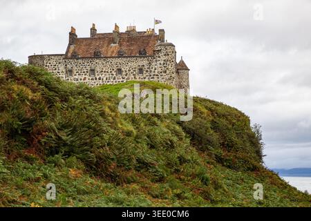 View of Duart Castle standing on a green hill covered in ferns under a cloudy sky in Isle of Mull, Scotland, United Kingdom. Stock Photo