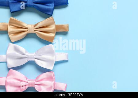 Different stylish bow ties on blue background Stock Photo