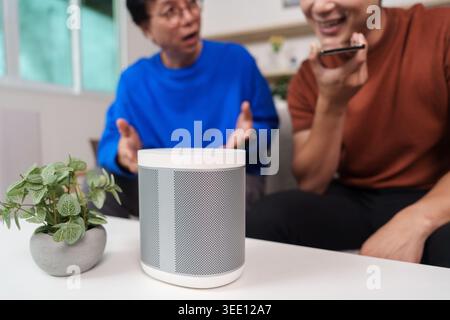 East Asian men using smart home voice assistant and AI technology Stock Photo