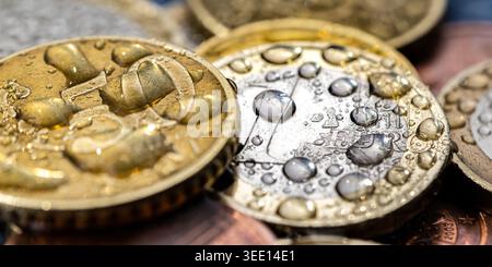 Close-up of multiple Euro coins with water droplets Stock Photo