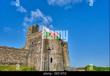Welsh flag flying outside the main gates of Kidwelly Castle, Kidwelly, Carmarthenshire Stock Photo