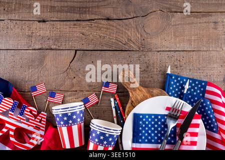 USA patriotic table setting with american flag, plate and decoration in national flag colors on white background. Independence Day. Happy Memorial Day Stock Photo