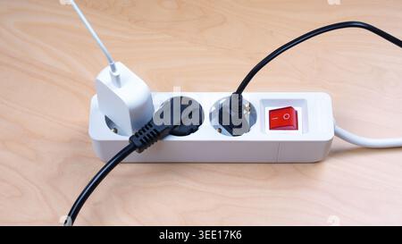 power outlet strip with multiple european AC plugs and charger in sockets Stock Photo