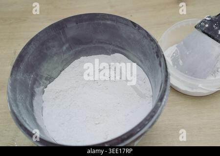 Grouting ceramic tiles using a fugue. Worker putting fugue on tiles closeup. tiles renovation Stock Photo