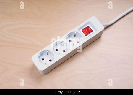 german multiple power outlet strip with three sockets and energy saving switch and extension cable Stock Photo