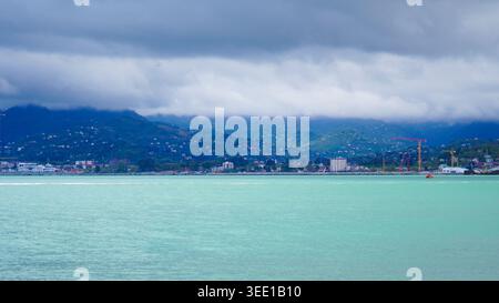 Panoramic view of Batumi coastline and green mountains under cloudy sky Stock Photo