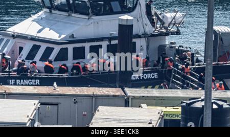 A group of people thought to be migrants are brought in to the Border ...