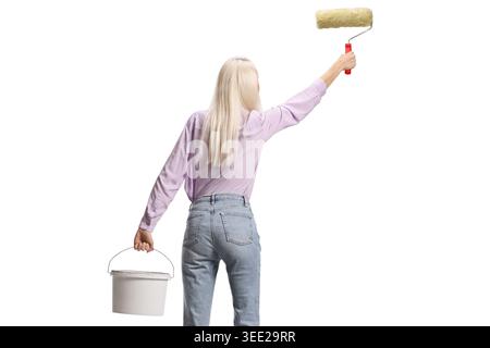Rear view shot of a woman painting a wall isolated on white background Stock Photo