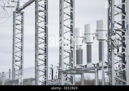 Detail of technical components at a power station including switchgear and steel support frames, conceptualizing utility maintenance and modern electr Stock Photo