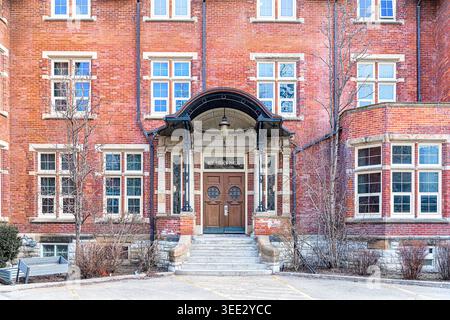 Front entrance of Annesley Hall with arched canopy, brick facade, historic windows, and stone staircase. Stock Photo