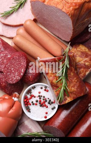 Different types of sausages, cured meat and spices on table, top view Stock Photo