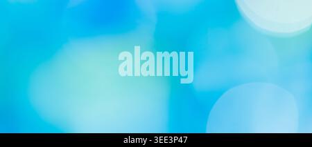 Abstract blue bokeh background with soft cyan and teal glowing circles and copy space Stock Photo