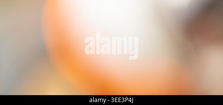 Soft orange and white abstract bokeh background with warm peach glow and copy space Stock Photo