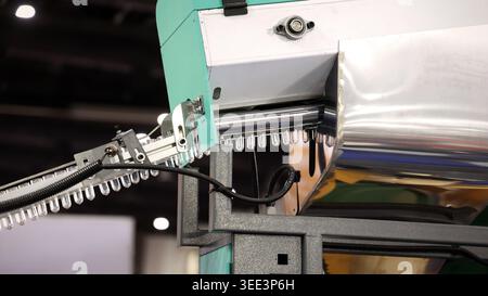 PET bottle machinery. Automated plastic bottle manufacturing machine operating on factory production line. Robot machine for bottle preform or forming Stock Photo