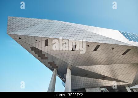 Lyon, France - March 19, 2026: Low angle detail of the metallic cantilevered structure of the modern Musee des Confluences under a blue sky Stock Photo