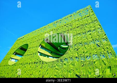Lyon, France - March 19, 2026: The Euronews Headquarters by Jakob + MacFarlane, featuring a vibrant green perforated facade and large circular voids Stock Photo