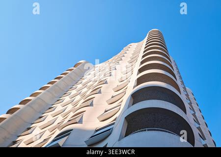 Lyon, France - March 19, 2026: Low angle view of the curved concrete facade and balconies of Herzog & de Meuron building in Confluence Stock Photo