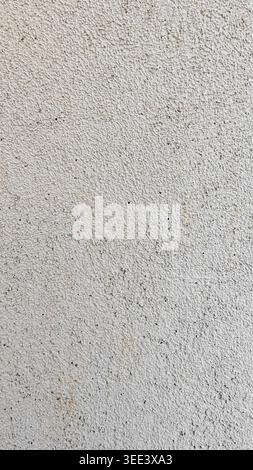 Neutral color backdrop features fine grain. Ideal as background or overlay. Studio shot shows soft lighting on raw, textured white surface, enhancing Stock Photo