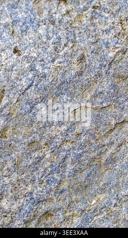 Detailed textural shot showcases natural granite. Highlights include varied shades, natural crevices, and mineral deposits. Perfect for backgrounds in Stock Photo
