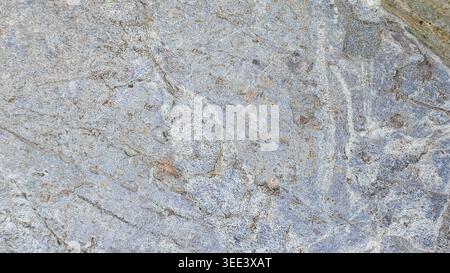 Detailed stone surface shot. Features intricate gray patterns, rough texture, and subtle coloration. Ideal background for graphic design, construction Stock Photo