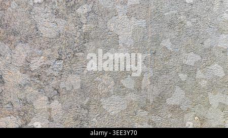 Close up of rough surface, a textured background in shades of gray and off-white. Industrial backdrop. Ideal for various materials and designs. Light Stock Photo