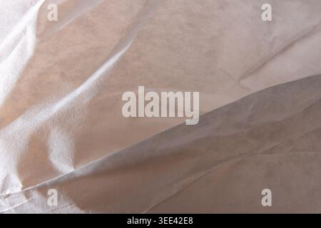 Close up of abstract crumpled light fabric texture with soft shadows creating an organic flowing pattern ideal for minimalist design and conceptual ba Stock Photo