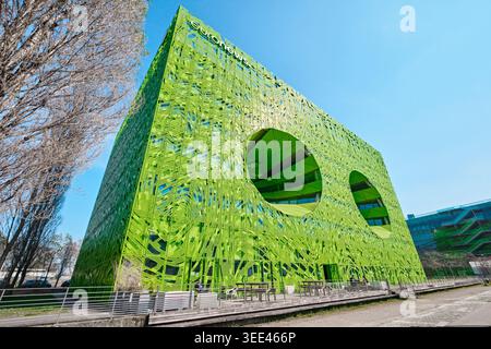 Lyon, France - March 19, 2026: The Euronews Headquarters by Jakob + MacFarlane, featuring a vibrant green perforated facade and large circular voids Stock Photo