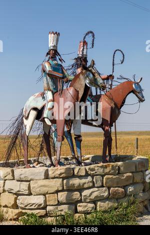 Metal statue of Blackfeet Indian warriors on horseback at the Canadian border with Montana, USA Stock Photo