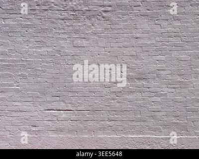 A view of a purple painted brick wall, as a background. Stock Photo