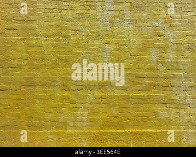 A view of a yellow painted brick wall, as a background. Stock Photo