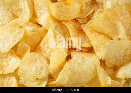 A top down view of a pile of potato chips, as a background. Stock Photo