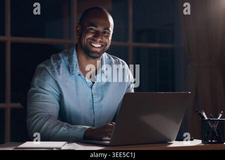 Night, laptop and portrait of businessman in home office for finance report, deadline and investor proposal. Dark, remote work and person on computer Stock Photo