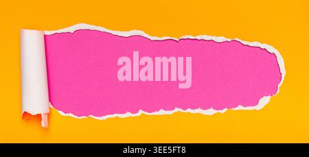 Bright Orange Paper Torn Open Revealing Vibrant Magenta Background with Rolled Edge Detail Stock Photo